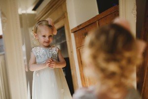 flower girl looking in the mirror