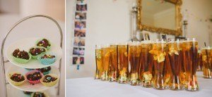 Left: A tiered stand holds colorful paper-lined cupcakes with chocolate and candy sprinkles. Right: A row of tall glasses filled with iced tea and fruit slices on a white tablecloth. Captured by wedding photographers Bristol, a large ornate mirror and photos form the elegant backdrop.
