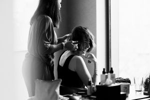 A woman sits and smiles