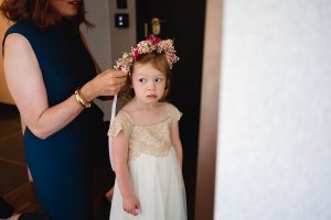 A young girl in a cream and gold dress