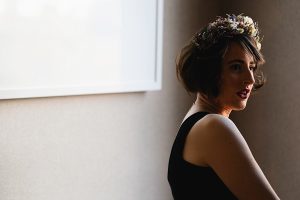 A woman with short brown hair wearing a flower crown