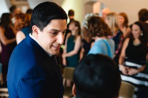 A man in a blue suit smiles