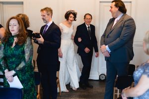 A bride in a white dress and floral crown