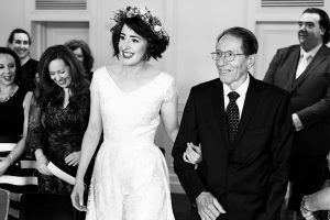 A smiling bride in a white dress