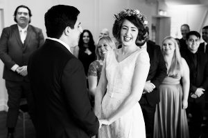 A bride and groom stand facing each other