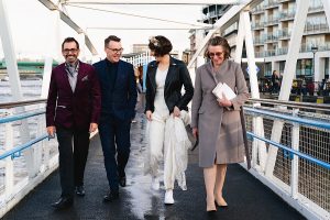 Four adults walk and smile together