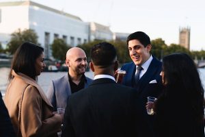 A group of five people dressed in formal attire
