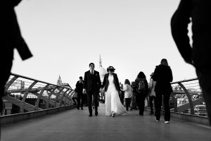 A bride and groom walk hand in hand