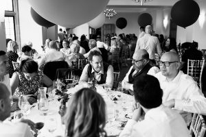 A black and white photo of people seated around a table